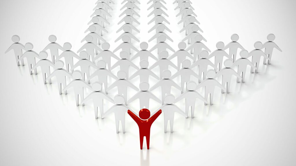 Groupe d’individus dont un leader en rouge symbolise la position dominante, représentant le rôle de LaserAddict comme leader du bien-être.